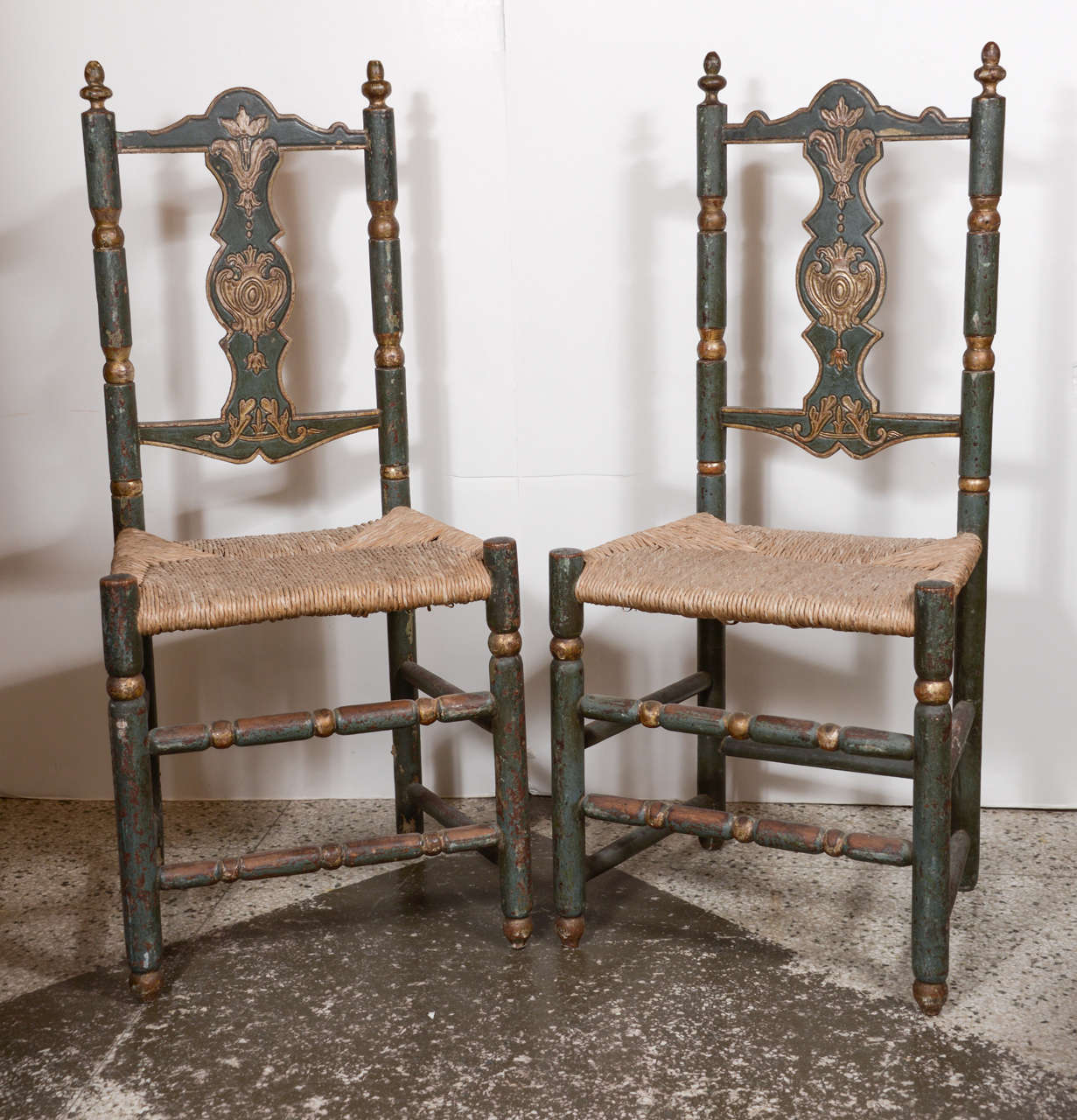 Six early Italian chairs (circa 1800) from Abruzzo, in original deep teal-green paint with traces of gilt, and later rush seats.