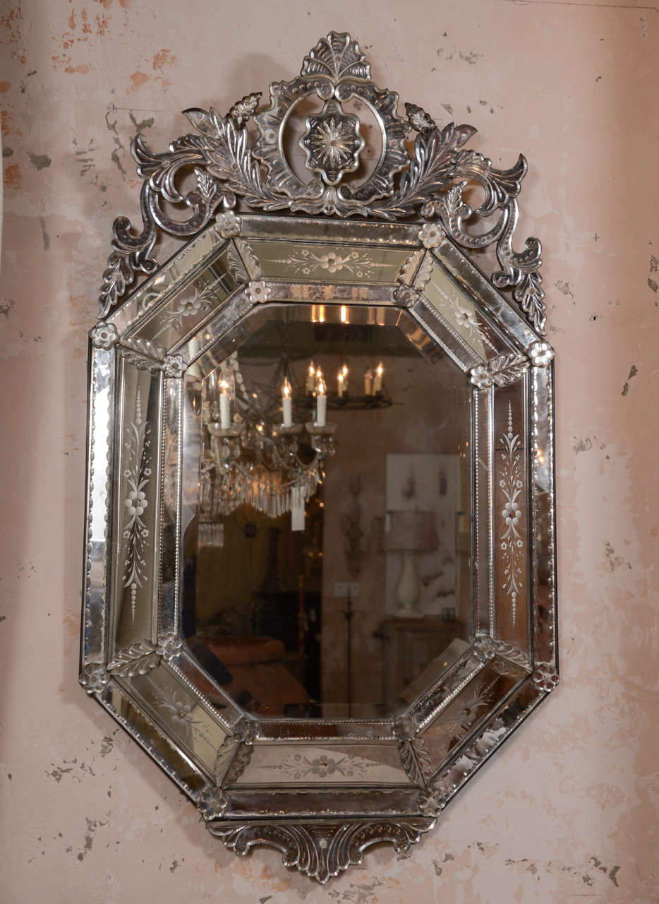 Octagonal Venetian mirror with top crown.