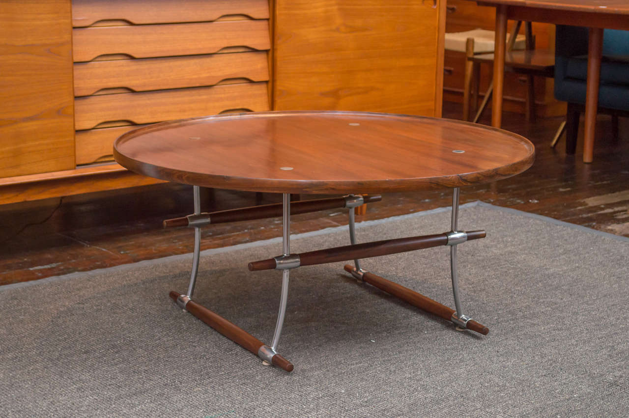 Jens H. Quistgaard design rosewood and chromed metal collapsible coffee table. 
Manufactured by Richard Nissen, Denmark. 
Perfectly refinished top and legs with minor pitting to metal chrome legs.