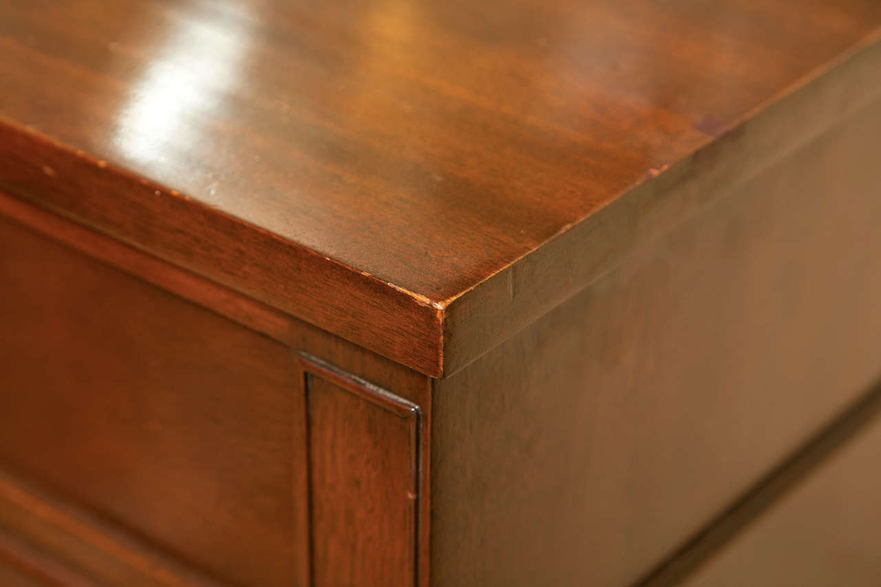 Pair of mahogany Bachelor's chests, circa 1950s, each has a rectangular top over a conforming case fitted with four drawers, decorated with brass loop pulls, stamped Kittinger Buffalo inside the drawer.