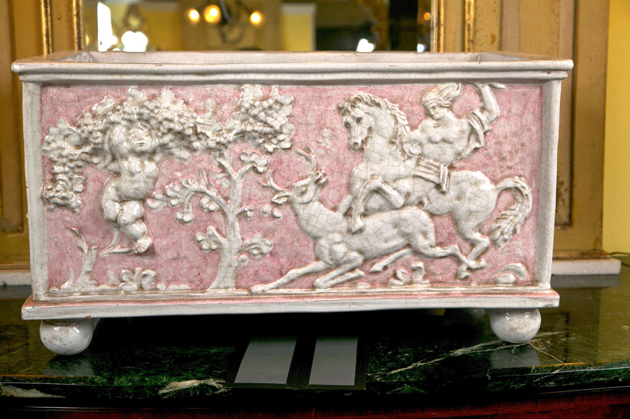 A Neoclassical Planter signed Ceccarelli, Italian circa late 19 century. Each side with a differant finely chased pictorial scene of hunters slaying deers  on horse back. The reverse having a warrior on a chariot killing two deer. In a pink and