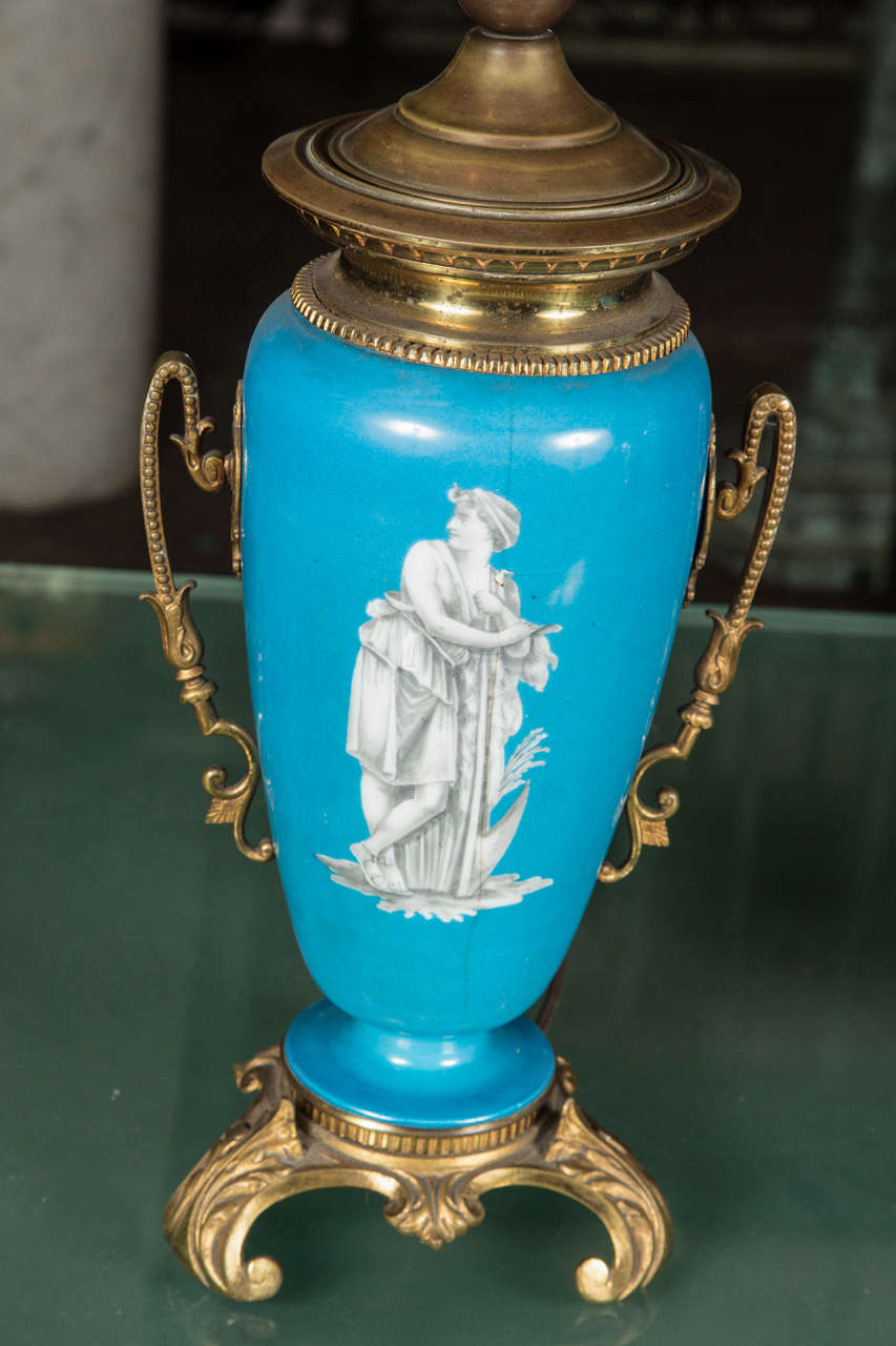 Bronze handles aside a turquoise color vase with a vignette center. Some imperfections. This can be seen at our 1800 South Grand Ave location in Downtown, LA.