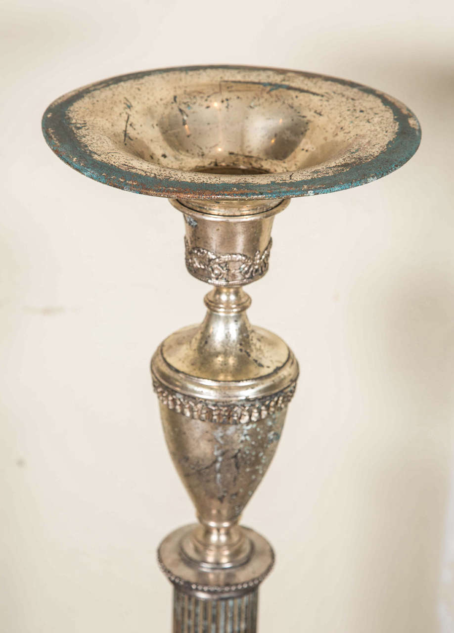 Silver plated bronze and copper candelabra. Medium size. Ornate legs with swags near base.