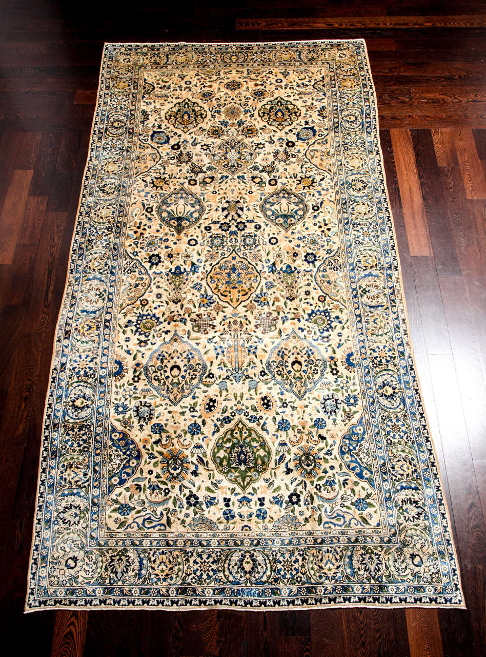 This Persian Lavar carpet created circa 1910 consists of a pure wool hand-knotted pile with cotton warp and threads and natural vegetable dyes. The work of master weaver Sakhaie, as noted by the carpet's signature, what is particularly impressive