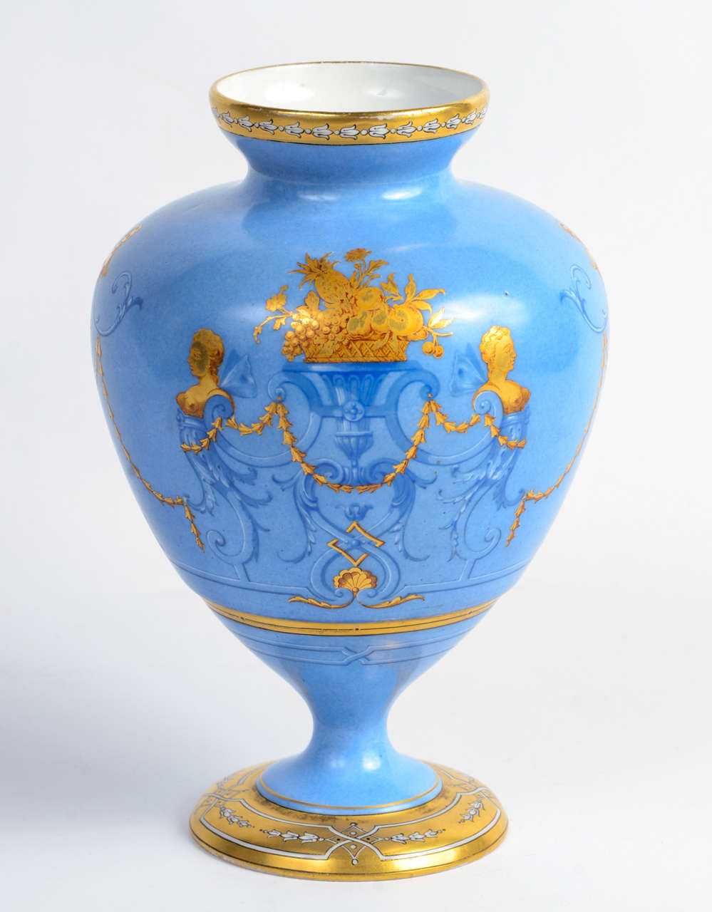 Very elegant porcelain vase with blue background gold decor representing a woman's busts and flower baskets surrounded with pearl garlands.
Bears the mark of 
