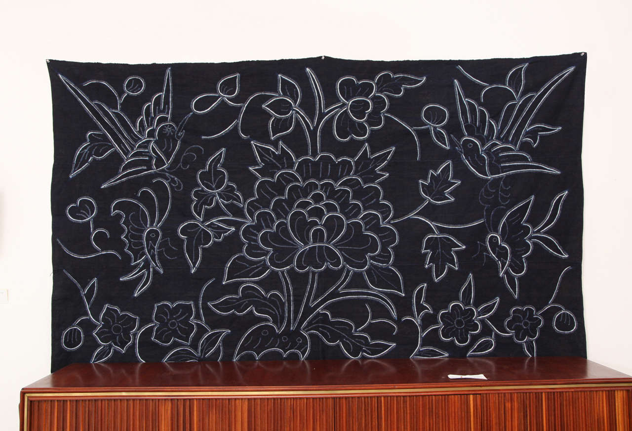 Indigo textile wall decoration tapestry with decorative flowers in white by Chinese Bouyei people, circa 1980.