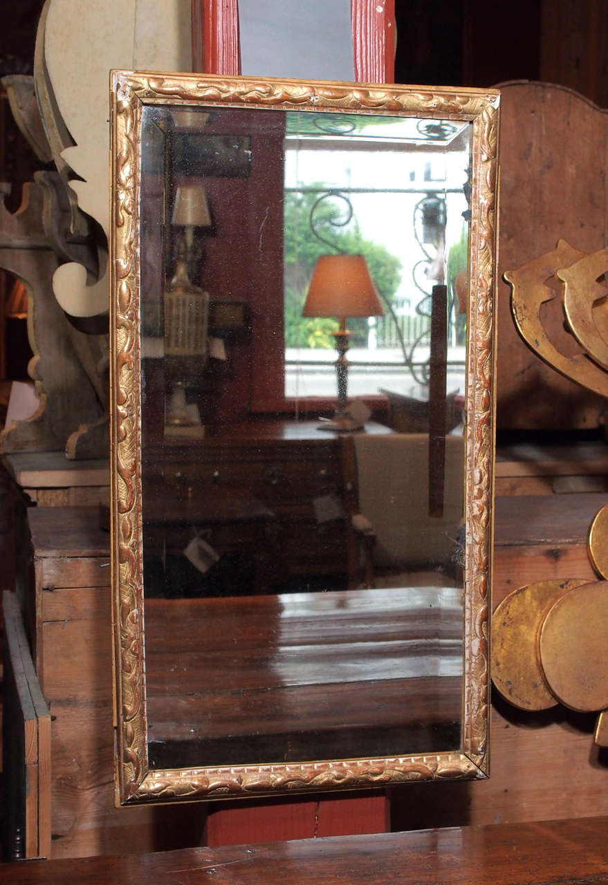 A french beveled mirror in a gesso and gilt frame.