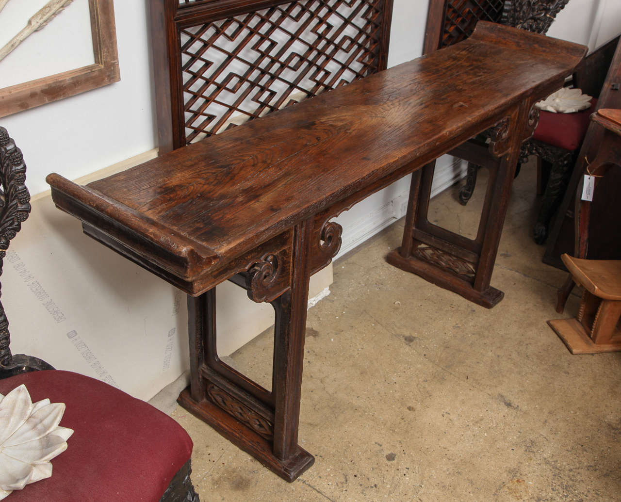 A Ming style altar table or console with everted flanges and carved leg panels. Elm wood. 18th Century, Suzchou