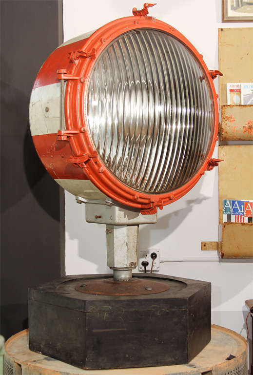 Enormous orange and white stripe maritime spotlight by Crouse Hinds, most likely from a marine or industrial installation.  This piece is mounted to a giant hexagonal wood factory mold and rewired for a standard household bulb.