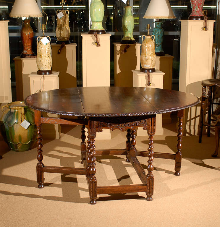 19th century oak oval barley twist gateleg center table with unusual carved apron.