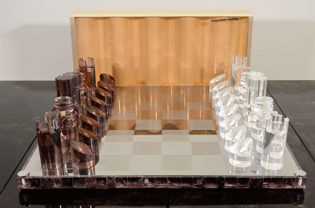 A Michel Dumas Stainless Steel and Lucite Chess Set