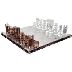 A Michel Dumas Stainless Steel and Lucite Chess Set