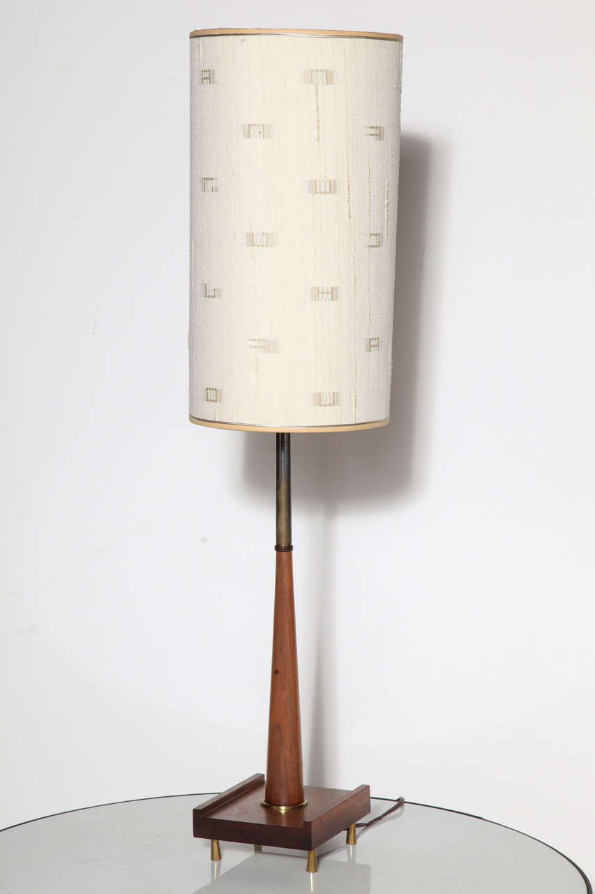 Slim Pair of American Mid Century Modern Paul McCobb style Walnut and Brass Table Lamps. Featuring a thin conical walnut lower stem and patinated brass upper, with rectangular (5 x 6) bases on four raised conical brass feet per Lamp. Shades shown