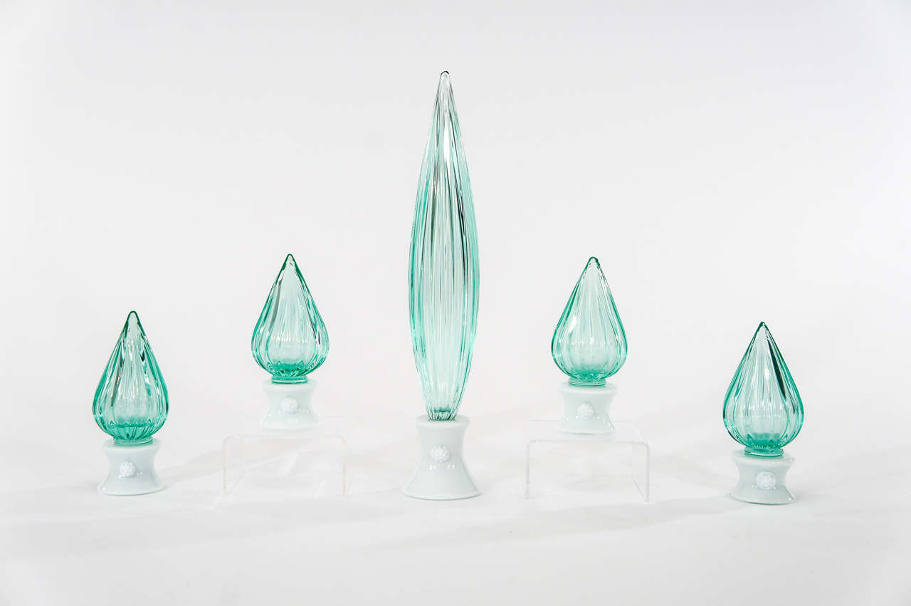 This is an interesting collection of hand blown ribbed crystal finial-like sculptures made by Venini. Extremely well-matched in clear crystal in a teal shaded green. Each piece is mounted on a white glass base, embellished with prunts, all with a