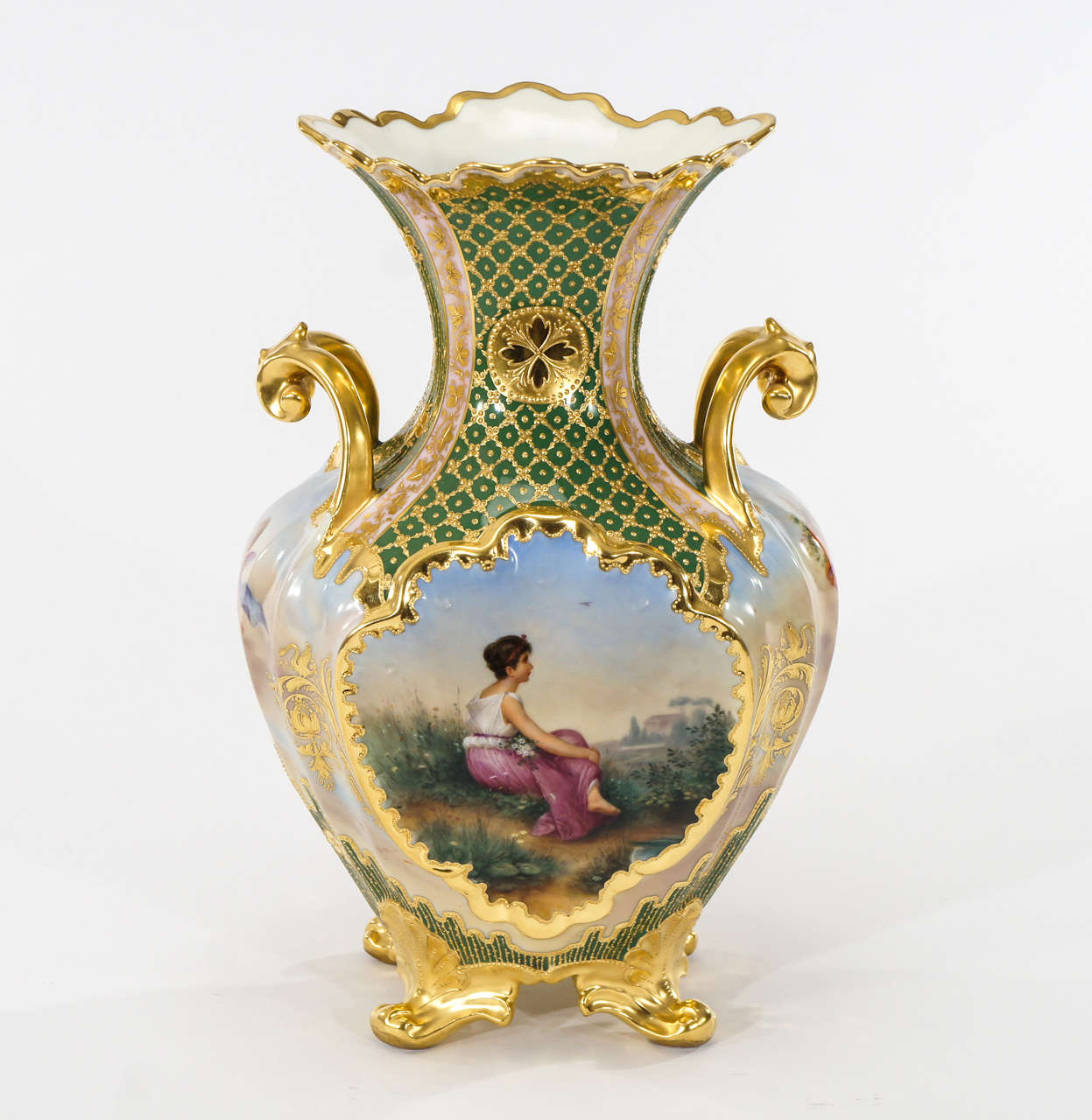 An extraordinary example of Vienna's renowned porcelain work. This vase is decorated on all four sides and completely hand painted with finely painted and detailed Romantic scenes of women and puttis. Every aspect is embellished with polychrome