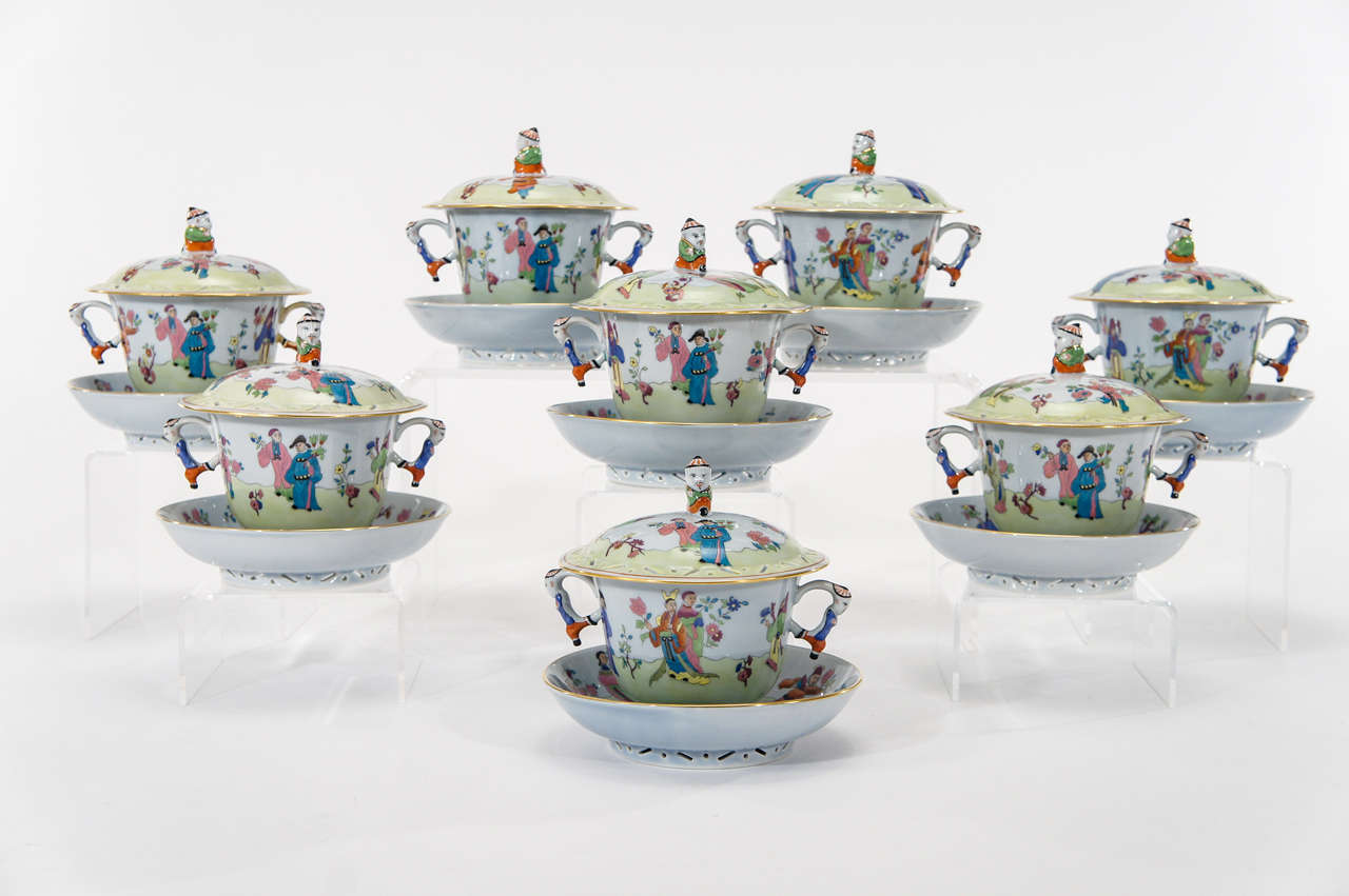 This is a charming set of eight Herend of covered cream soups with matching under plates. The rims of all three pieces have the added pierced decorative elements and as they are large, they can be used for more than just soup..think desserts,