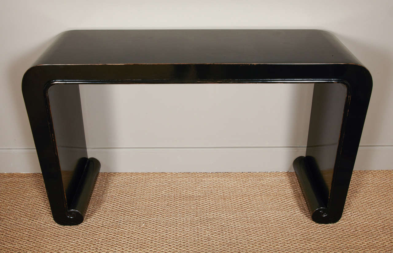 Nice and elegant shape for this black lacquered table with scroll legs.