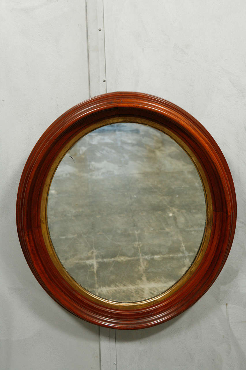 A nice size oval, late 19th century, mirror having a raised and molded frame. The mirror will make a nice accent in a powder room or other setting. Jefferson West antiques offer a selection of mirrors, furniture, lighting, decorative elements and