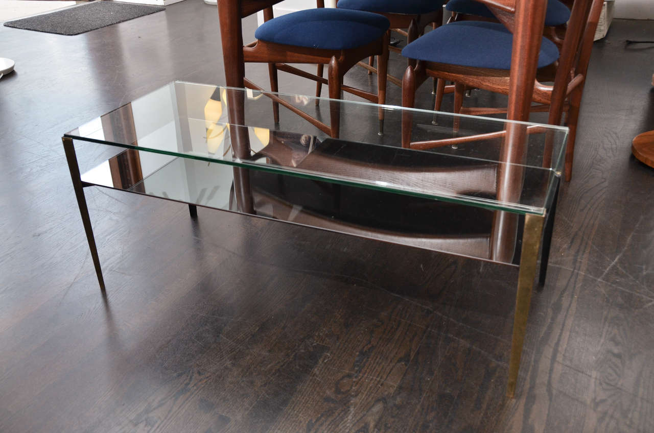 Simple, elegant and functional coffee or cocktail table. Suspended on tapered brass legs are two levels of glass. Designed by Gio Ponti and manufactured by Fontana Arte ca. 1955. Glass is original to the piece.

 