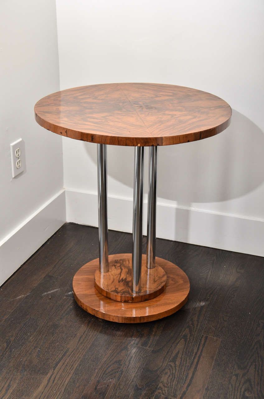 Pair of crotch walnut Italian side tables. The base is double tiered from which three stainless steel posts support the round crotch walnut top. All original.

 