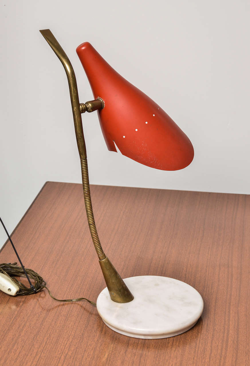 Italian Table Lamp by Lumen
Adjustable Red Metal Shade connected to a Brass Flexible Arm Standign on a Round Carrara Marble Base