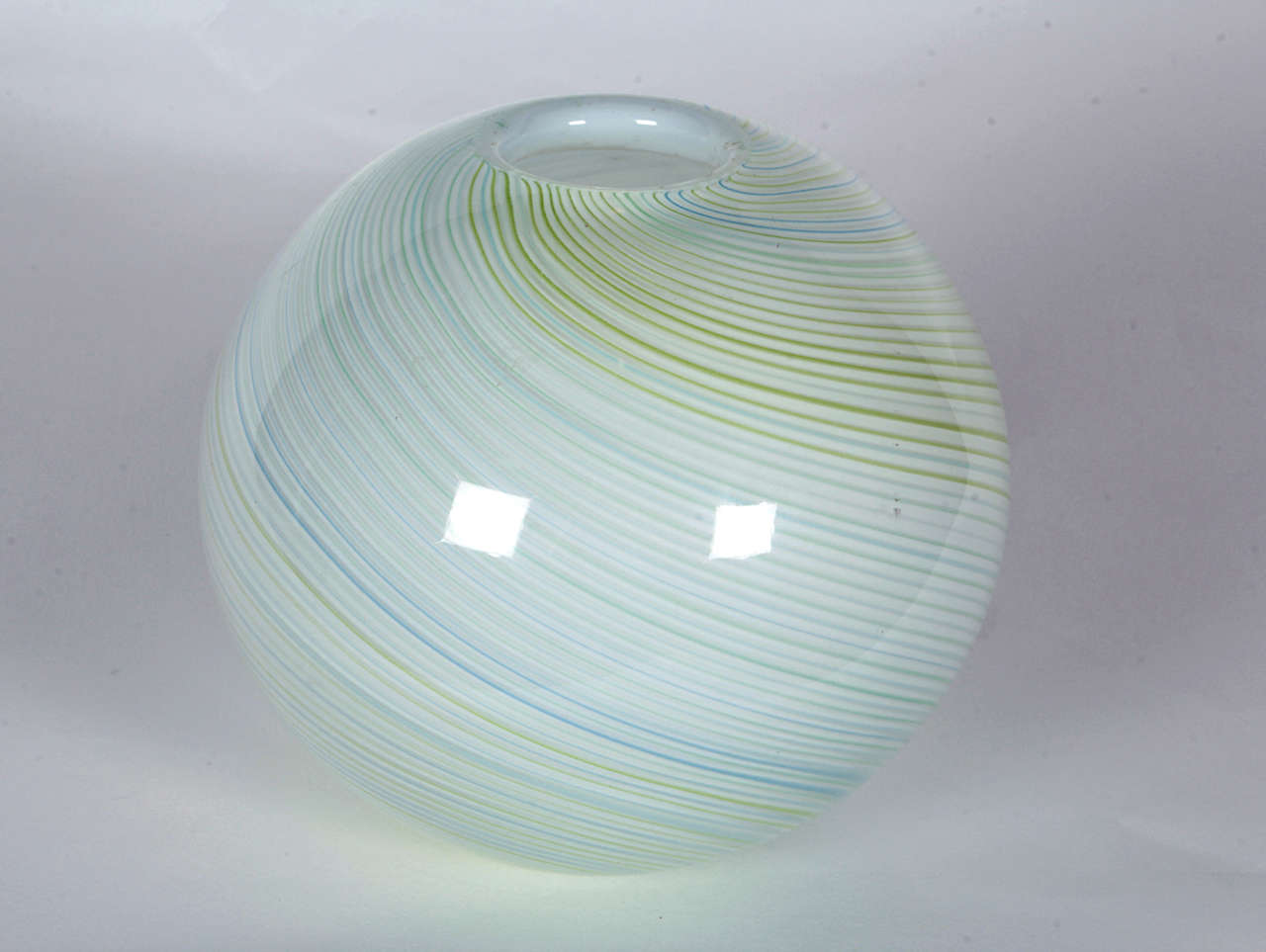 Spherical mezza filigrana vase attributed to Carlo Scarpa, VENINI, Murano. Designed in 1934, executed 1946-65.  Features a multi-color swirl pattern on white.

Item may be viewed at our showroom (see display case) in the New York Design Center.