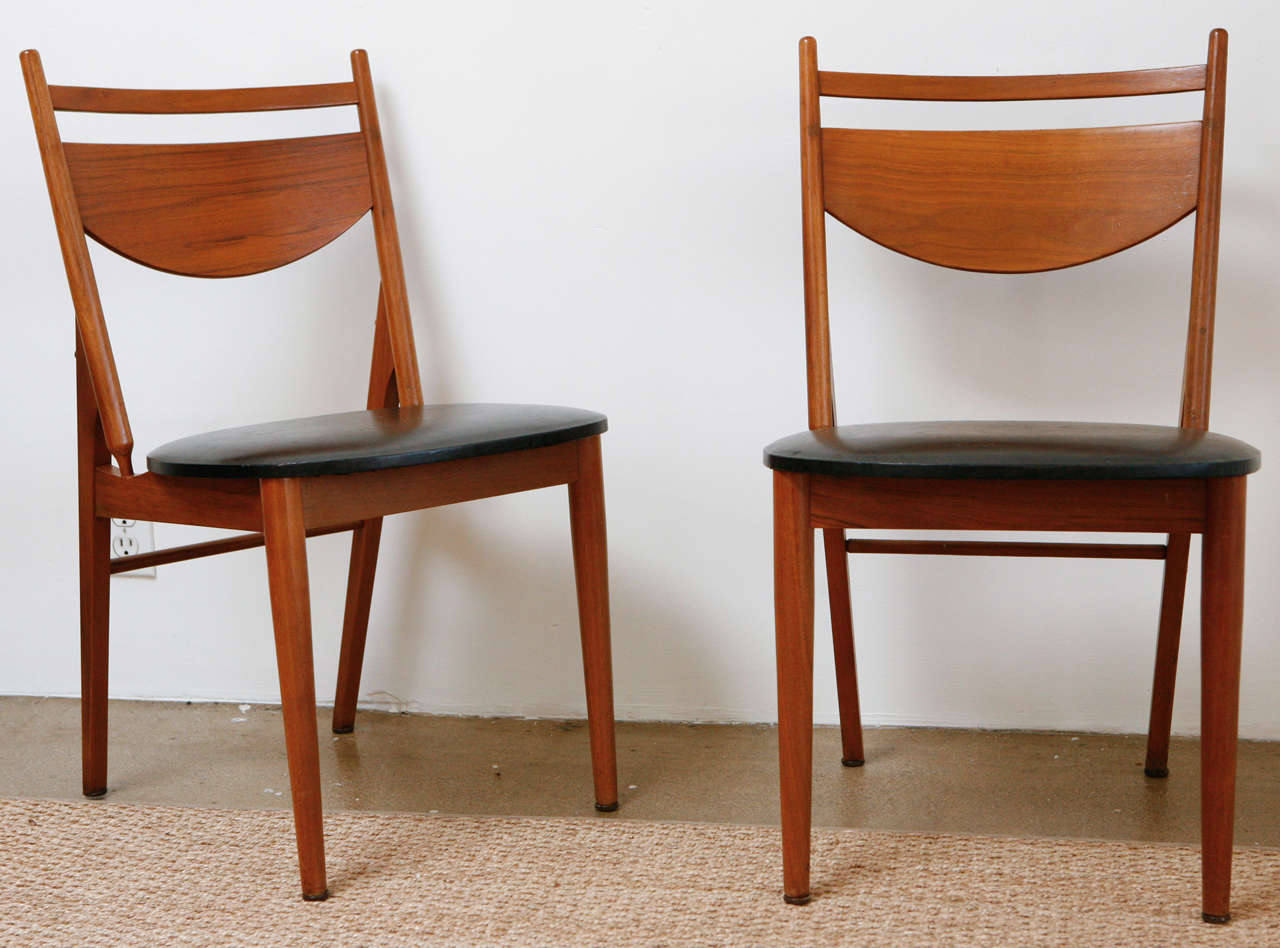 With their original black vinyl upholstered seats and warm mahogany finish, this set of six Stanley Young for Glenn of California dining chairs are truly wonderful additions to any dining space. Modern mid-century minimalism at its best!