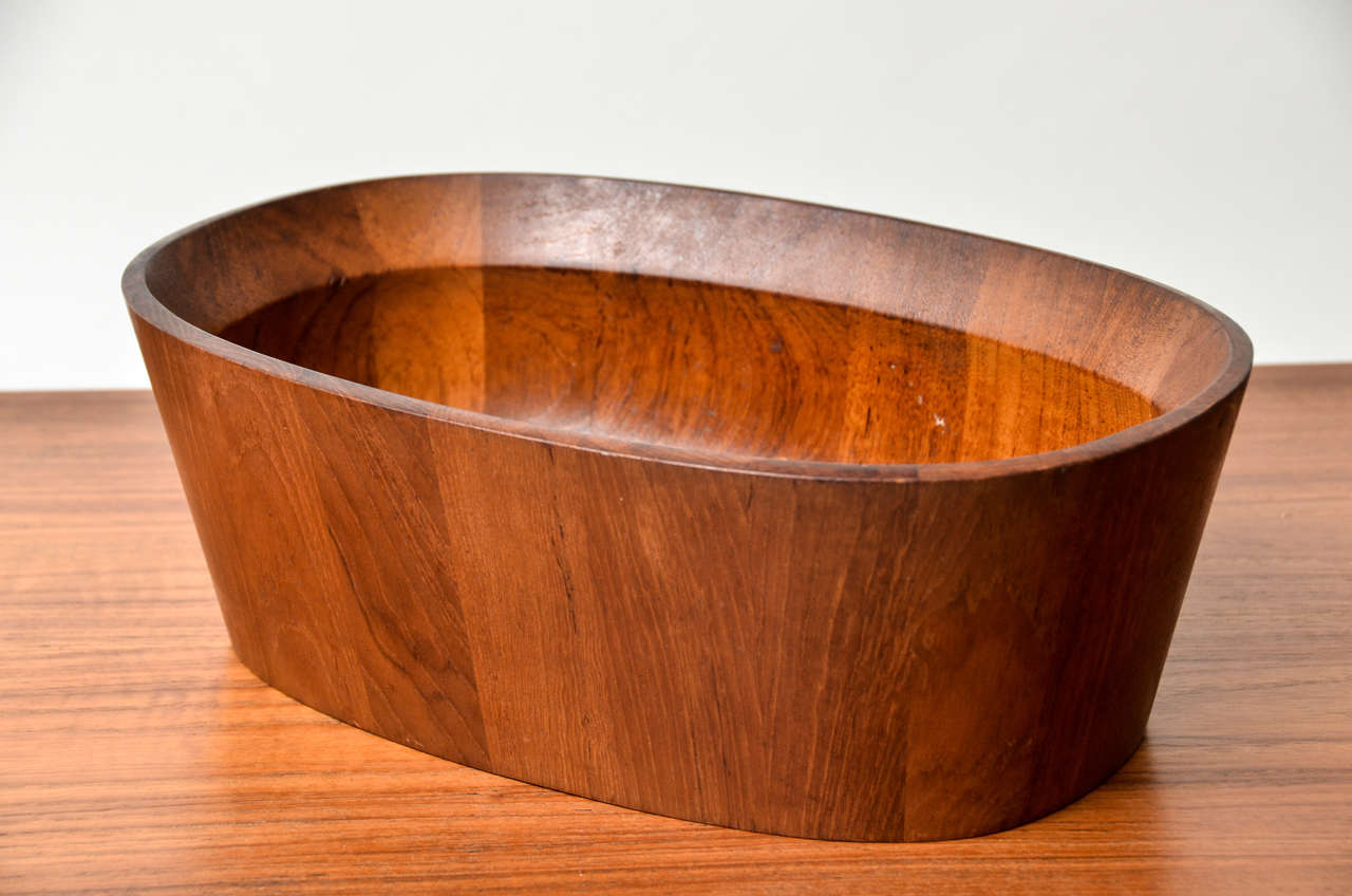 Oval Vessel constructed of staved teak, designed by Jens Quistgaard (Danish, born in 1919, deceased).  Sturdy and useful bowl.  Unusual form by Danish master of wood, metal & enamelware.  Marked with JHQ on base.