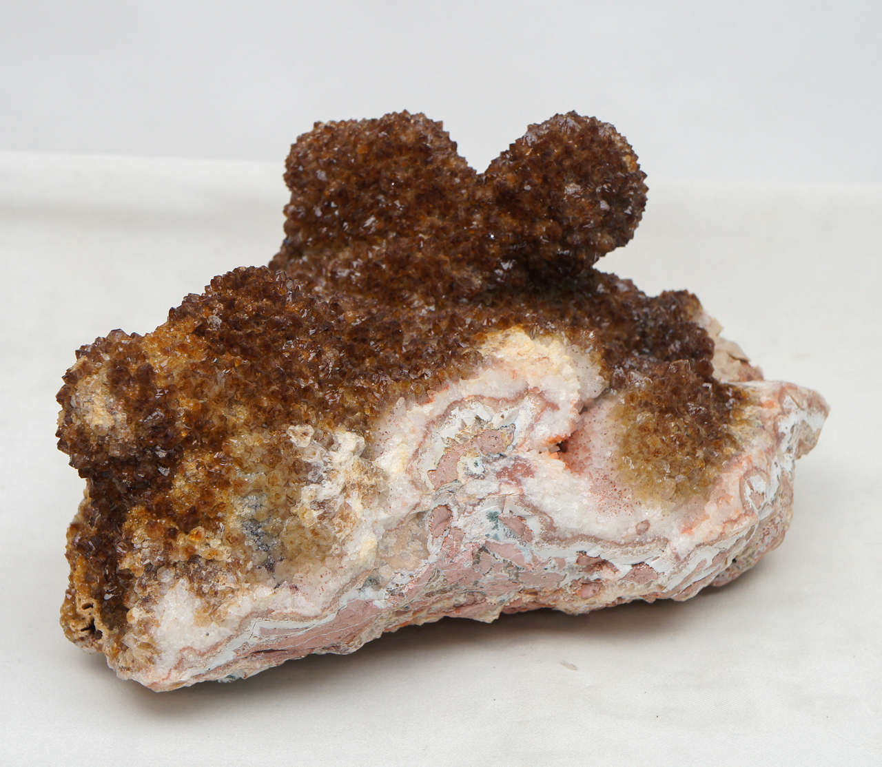 I recently acquired a number of geodes from a serious collector. While they are all exceptional specimens, this one is surely my favorite. The variety of textures is amazing; rich, almost glowing embers on the rough exterior, with shades of pinks