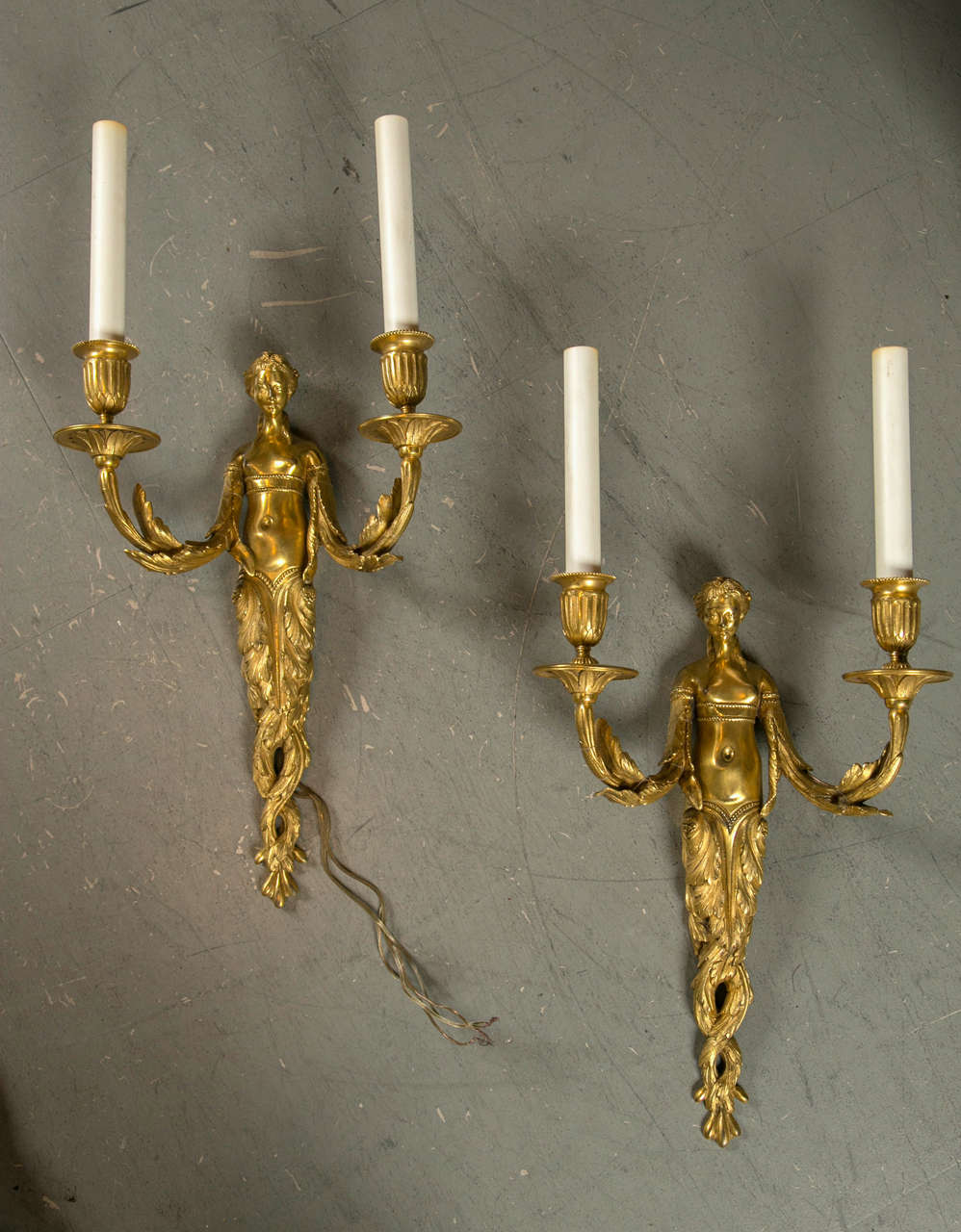 A beautiful pair of circa 1800 bronze nude figural sconces. All original gold gilt ormolu.