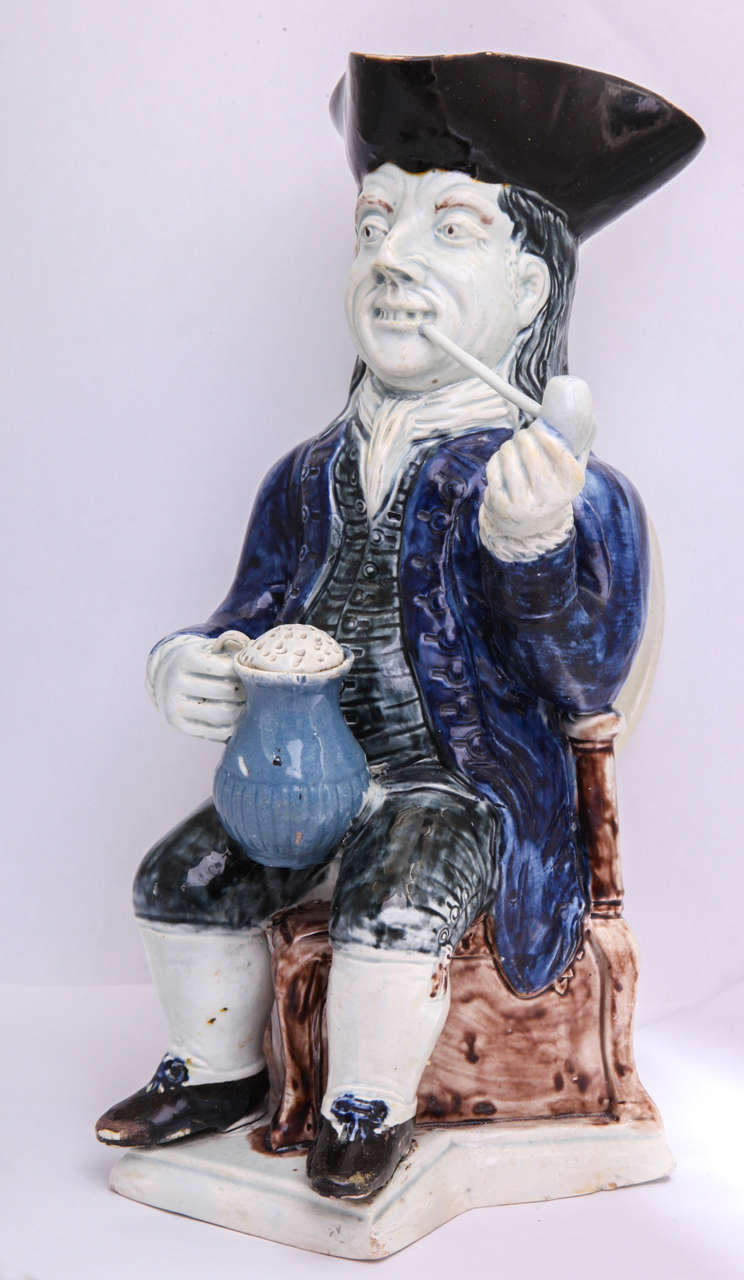 A rare Wood family pearlware pottery  squire toby jug decorated in underglaze colors