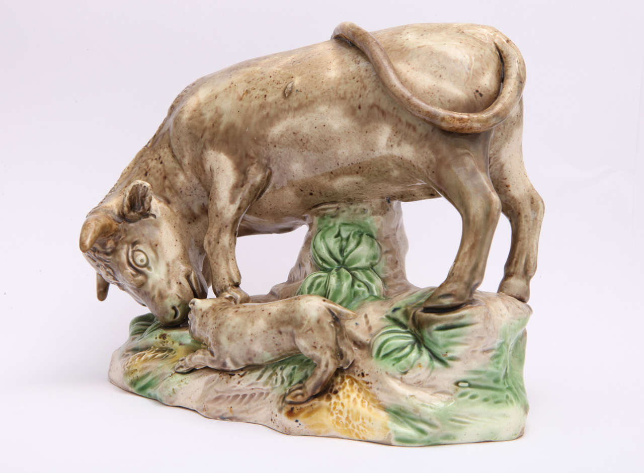 A fine Ralph Wood Sr.pottery bull baiting group, the bull being baited by the dog, decorated in translucent glazes, Stoner & Evans label on base