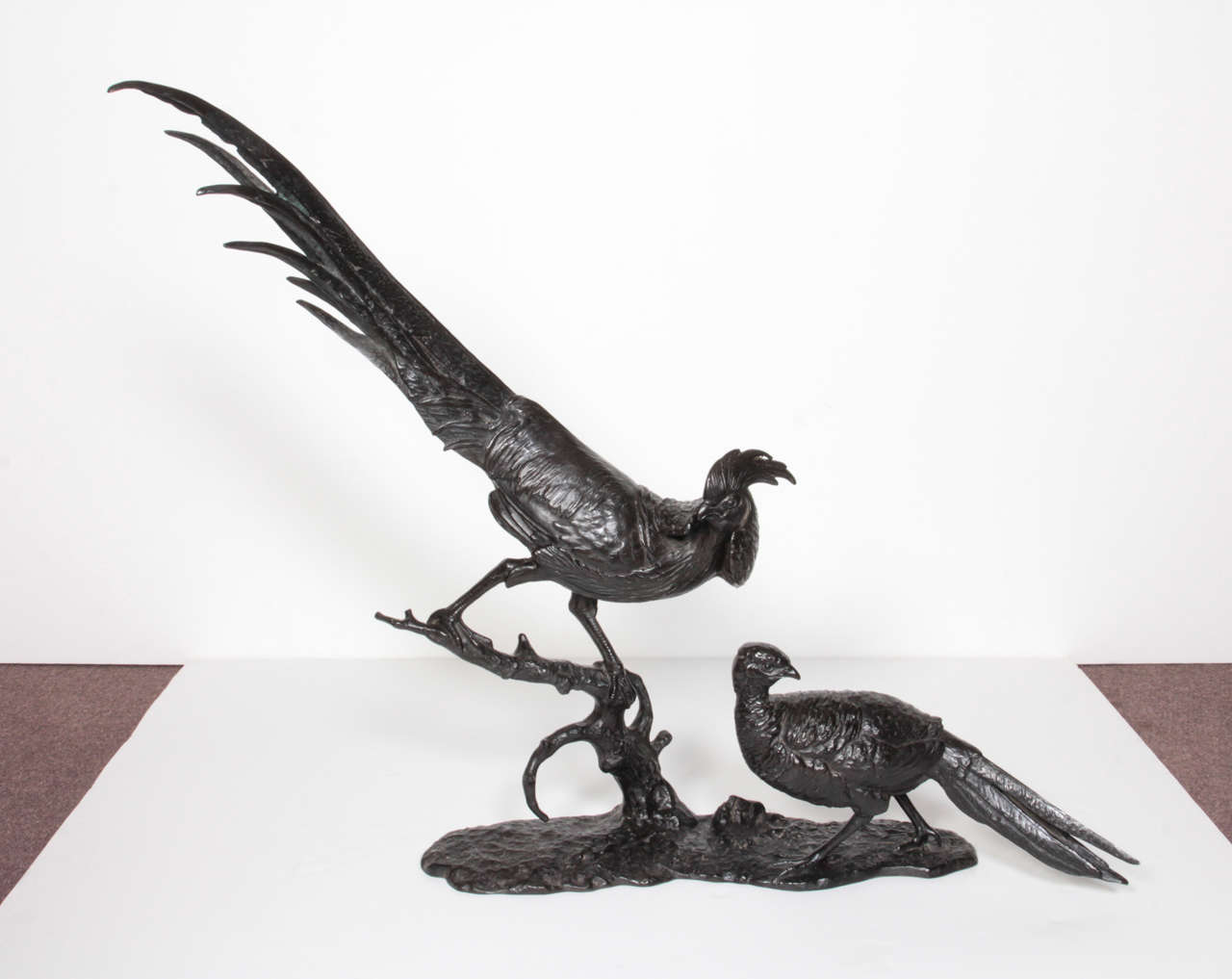 A finely cast original bronze grouping of a male and female pheasant in the style Japonaise with original patina- signed: A. Buschelberger
Large and important scale, beautiful execution, attentive detail, realistic rendering and of highly
