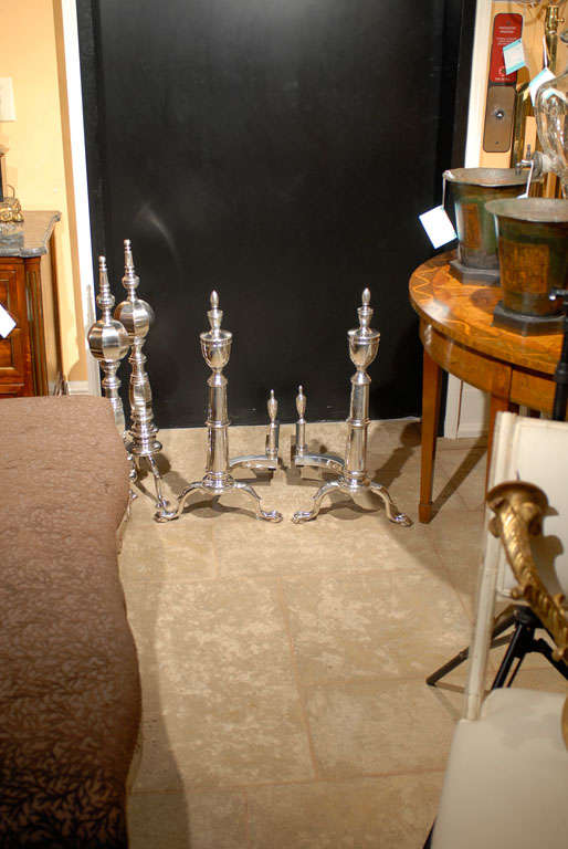PAIR OF 20thC AMERICAN SILVERED ANDIRONS WITH URN FINIAL<br />
BALL & CLAW FEET<br />
AN ATLANTA RESOURCE FOR FINE ANTIQUES<br />
WE HAVE A VERY LARGE INVENTORY ON OUR WEBSITE<br />
TO VISIT GO TO: WWW.PARCMONCEAU.COM