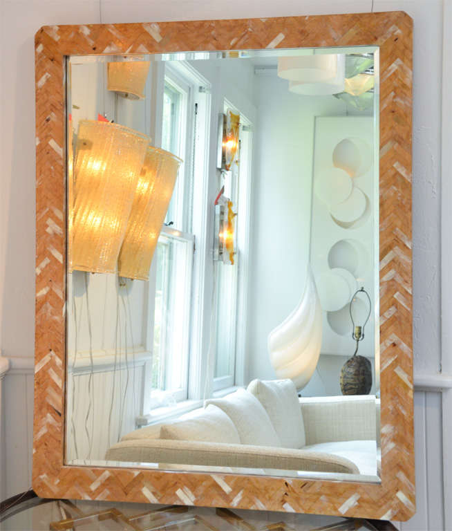 Bone mirror with herringbone pattern.