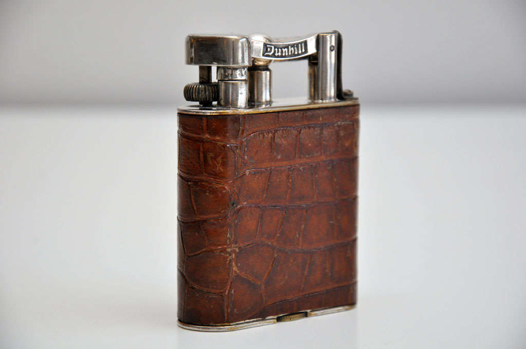 A large Alfred Dunhill lighter, wrapped in alligator.  An elegant accessory for a side table or desk.