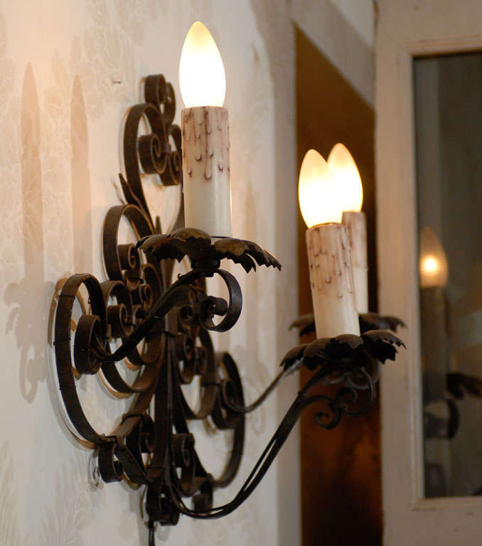 Pair of Vintage Black Iron Wall Sconces from France, Circa 1920
Here is a pair of old French iron wall sconces with wonderful scroll work.  Each fixture has three lights.  They have been recently rewired so are ready to install.
