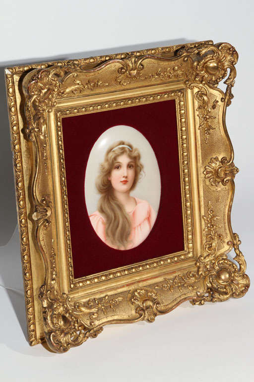 Oval hand painted portrait of a beautiful young woman by well known artist Wagner, signed by the artist. The KPM plaque is signed with the impressed KPM and sceptor mark. It is mounted in an ornate gold gilt frame with burgundy velvet. Listed size