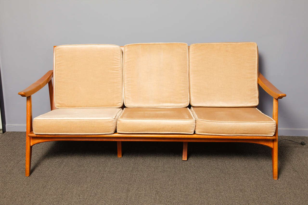 Italian origin teak wood three-seater sofa with its original cushions.