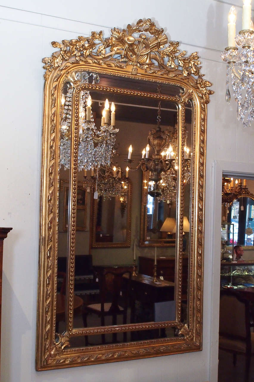 Antique French gold leaf cushion mirror with 
