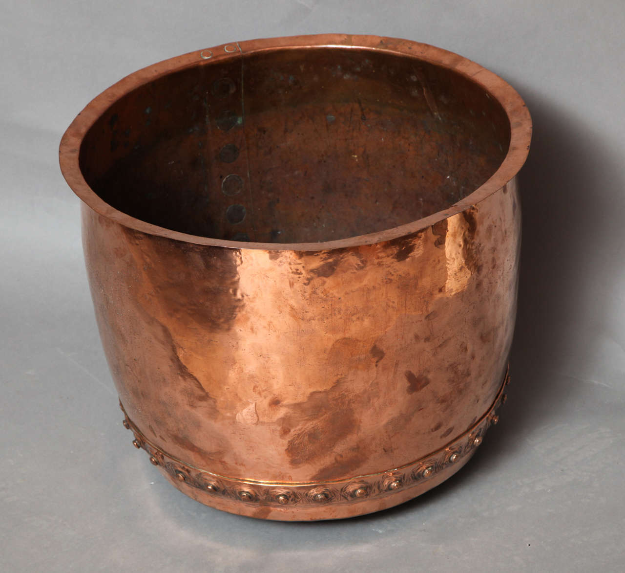 A great late 18th century/early 19th century English copper log container a profusely hand hammered and rivetted surface.  Beautiful patina and good scale.