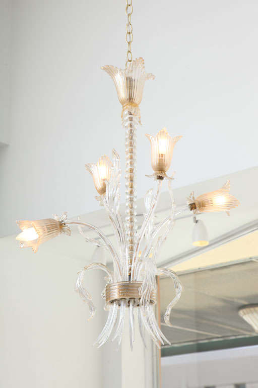 Fantastic very early (1938) handblown Murano glass chandelier with tulip cups and leaves and plumes. It is filled with gold flecking and has a stacked glass-over-cord center sling and brass accents. Some of the flowers are broken in places yet