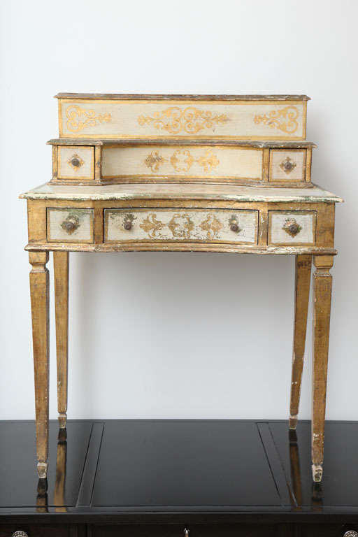 Lovely gilded writing table with top detached secretary. Table itself has three drawers while the top secretary has two drawers. Both have concave centers. Original naturally patinated condition with a lot of wonderful ware. From natural usage the