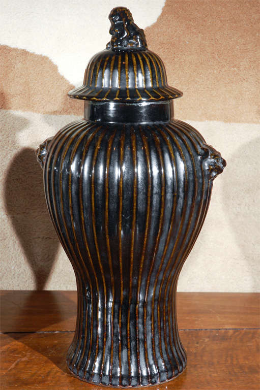Pair of chic, black, ribbed Chinese vases with Foo Dog lids.