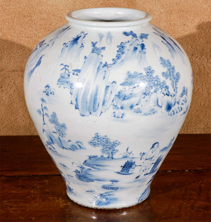 Beautiful, globular, c.1885, blue and white, ceramic vase from Korea featuring villagers, mountains and a delicately painted stand of trees.
