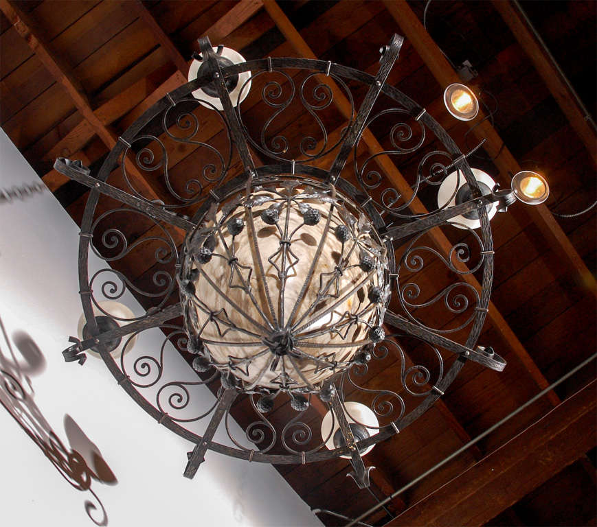 Finely wrought iron and alabaster fixture featuring flowers, leaves, and pods. Four lights, newly wired.