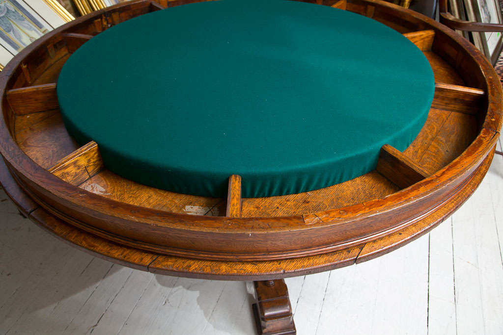 AN OAK GAMES TABLE WITH FELT TOP, DEEP APRON, CENTRAL COLUMN FROM WHICH EMINATE 4 SPINDLED LEGS
Please feel free to contact us directly by clicking on  CONTACT DEALER link on this page.