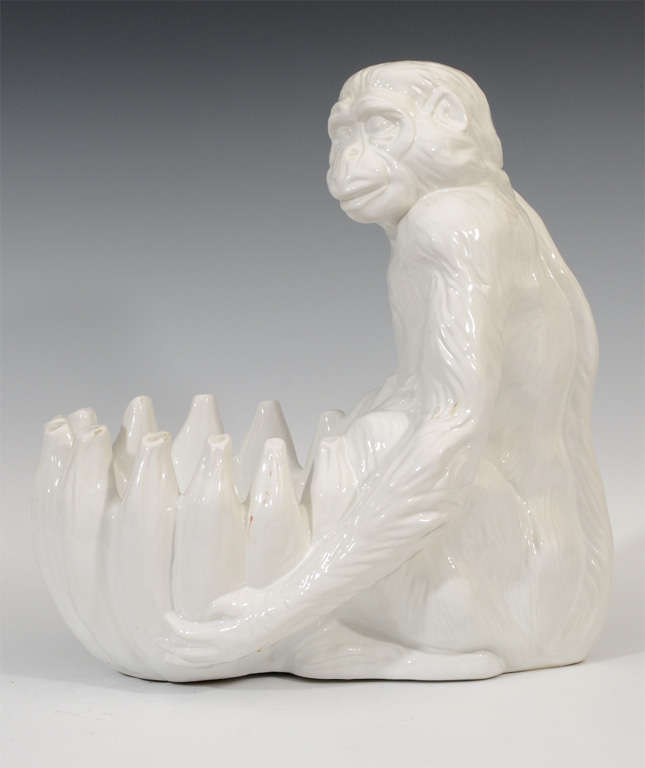 A vintage ceramic blanc de chine majolica bowl in the form of a monkey and holding bananas