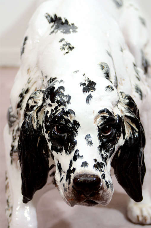 A vintage Italian ceramic sculpture of a black and white dog, likely an English Setter. The piece is unmarked and near life-size.