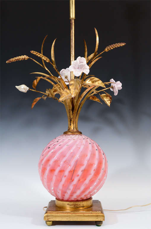 A pair of table lamps with pink and white swirled Murano glass bodies and tole and ceramic flower details.